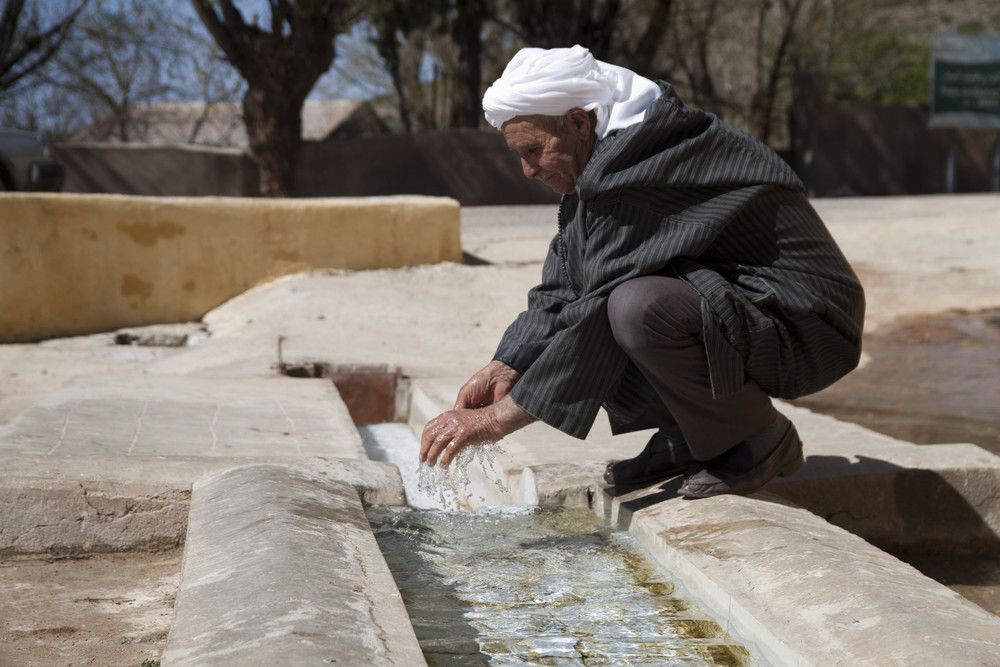 A village leader inspects a sealed, improved spring that delivers water to his community. Morocco's Orientale Region, 2013.