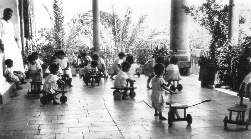 Birds' Nest children with kiddie cars built for them by older orphan boys at NER's Maameltein industrial workshop, c. 1922.