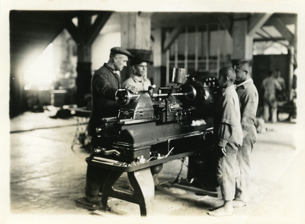 Older boys learning skills for self-support in a machine shop in the Caucasus