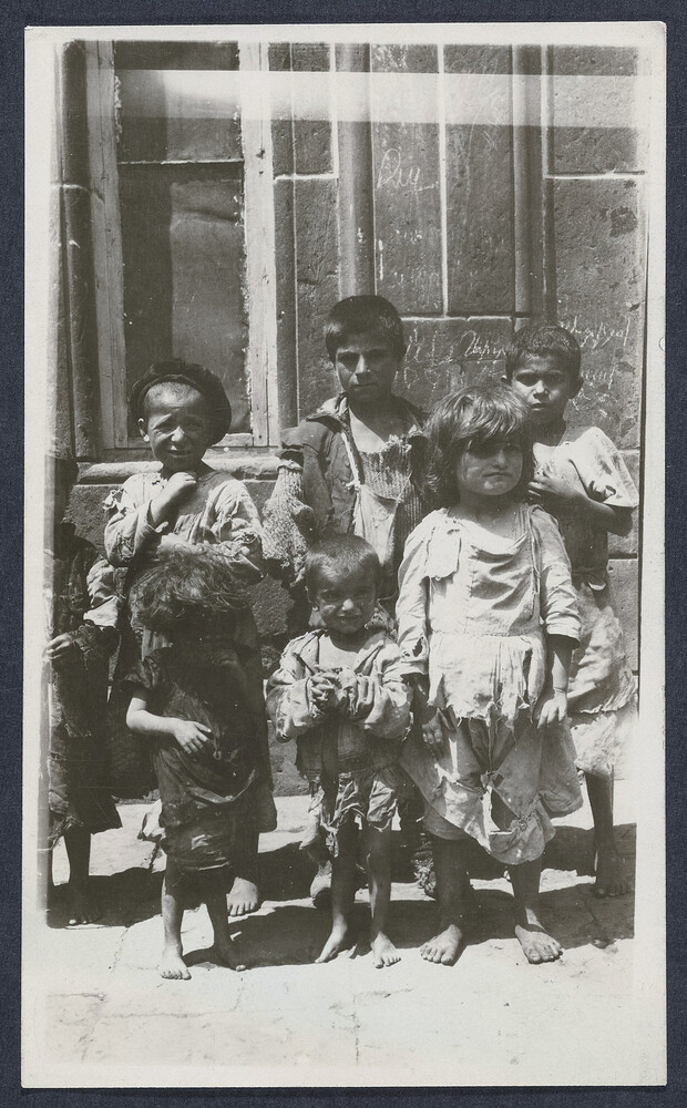 Ragged, barefoot children in a doorway. Alexandropol, c. 1923–1926.