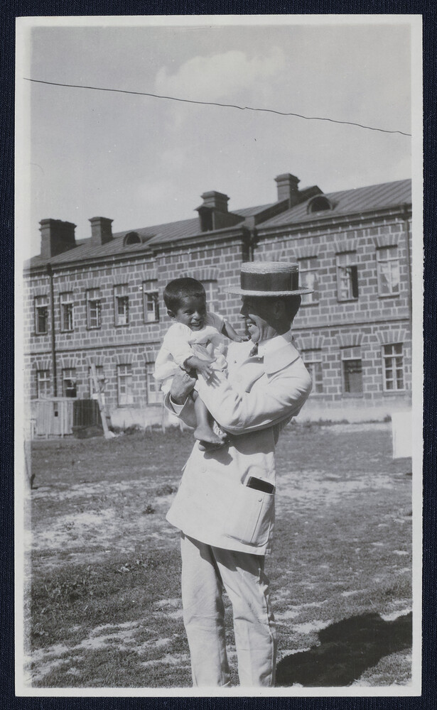 Barclay Acheson lifts a small child. Alexandropol, c. 1923