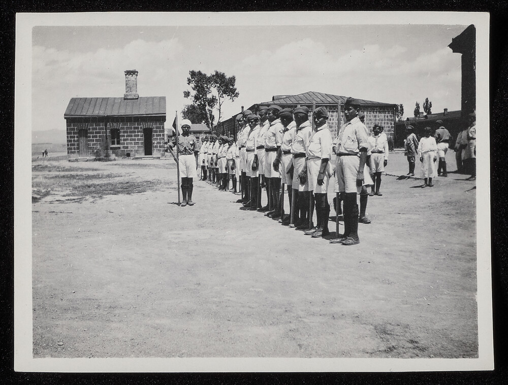 Uniformed orphan boys at drill with flag, Caucasus, 1920s