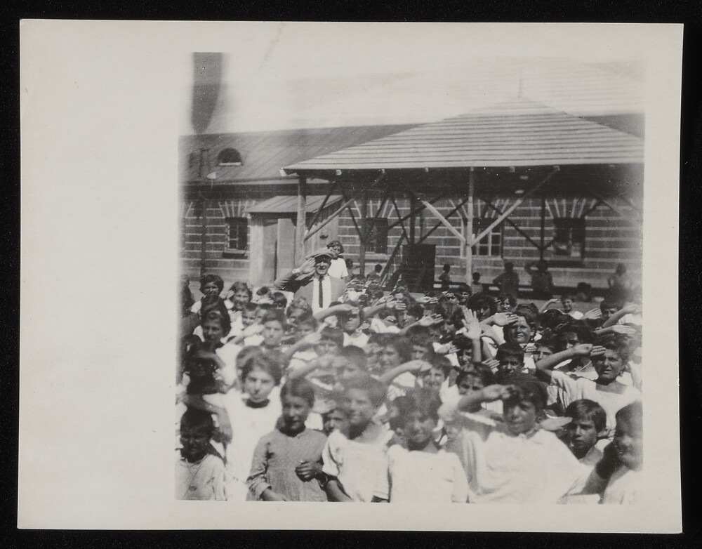 Relief worker amid a crowd of children, Caucasus, 1920s
