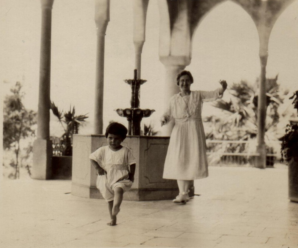 Nellie Miller watches a small child on the Birds' Nest porch. Sidon, c. 1923.