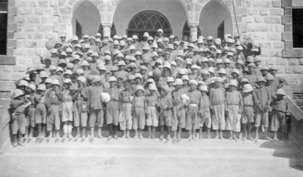 Boys of the Sidon orphanage gather on the steps. Sidon, 1919–1920.