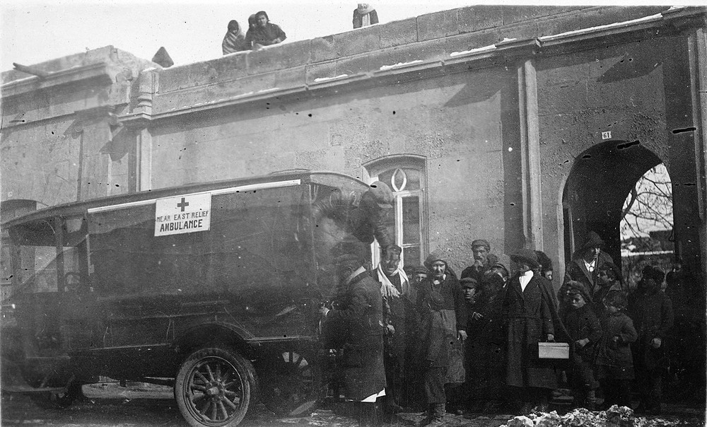 A group stands beside a Near East Relief ambulance.