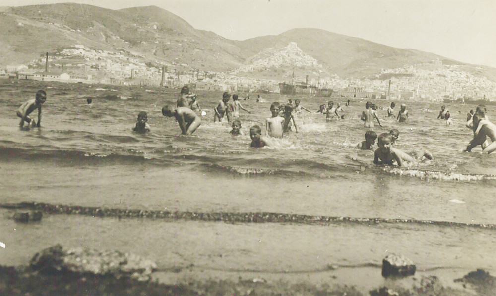 Orphanage children swimming off the shore at Syra, 1927