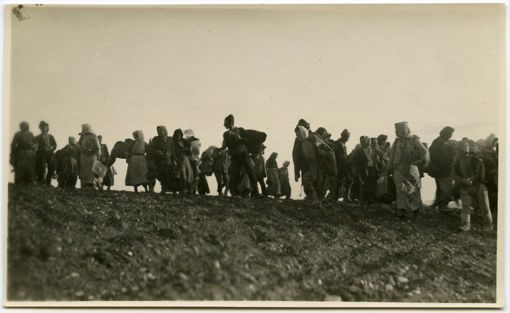 Armenian refugees leaving TurkeyA file of Armenian refugees with bundles crosses a bare ridge, fleeing Anatolia southward toward Aleppo and Beirut, c. 1921–1923.