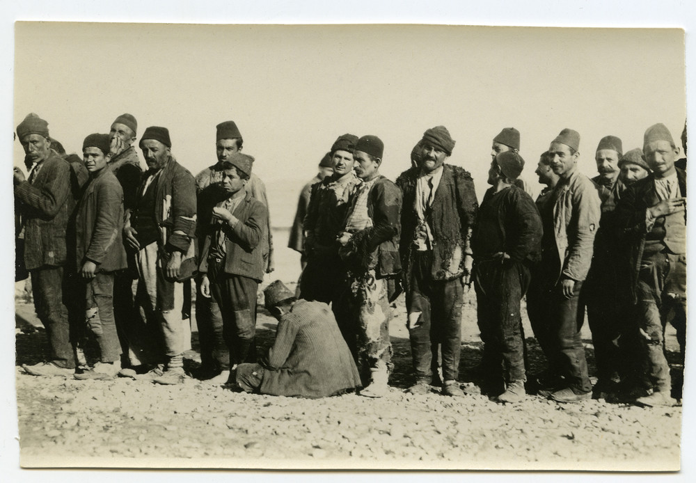 Refugee men and boys queue on open ground for a food distribution, possibly Aleppo, c. 1921–1923.