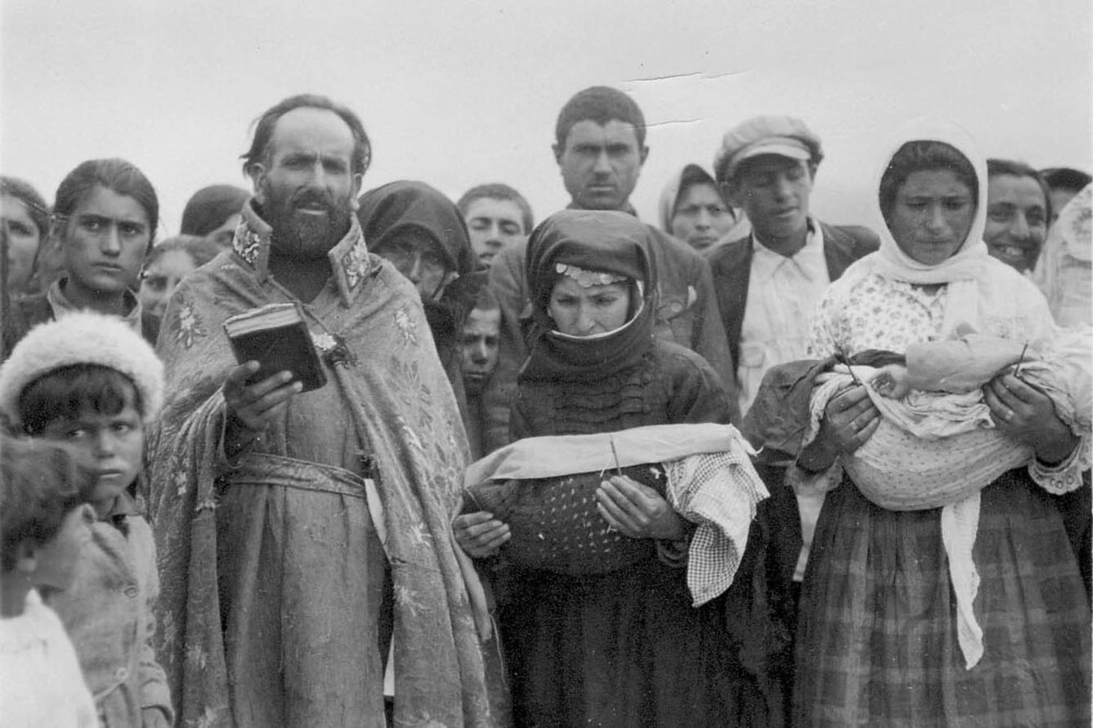 Armenian priest at an outdoor ceremony with refugees