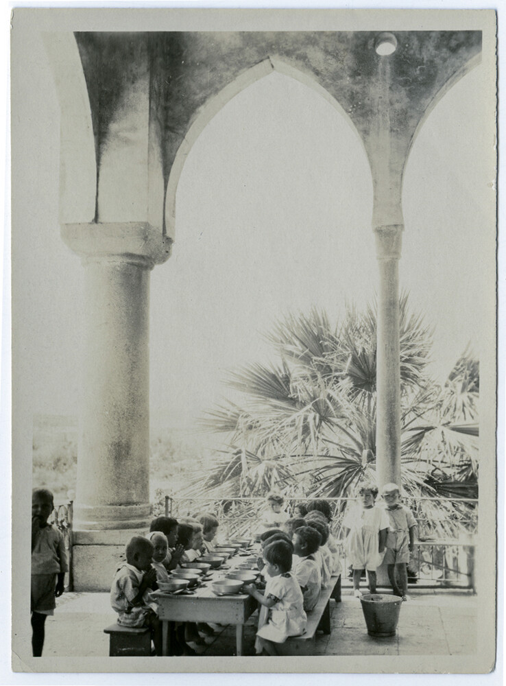 Children at prayer before dinner on the terrace of the Birds' Nest Orphanage in Sidon, ca. 1923.