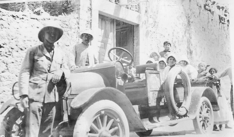 Children load into the car outside the shelter. Beirut, c. 1919–1920.
