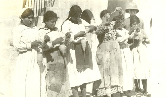 Seven girls spinning wool in the barracks. Aleppo, c. 1919–1920.