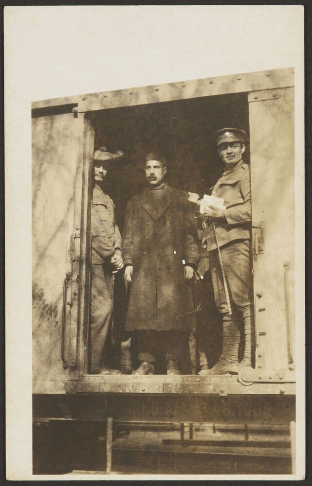 Three men in train car doorway
