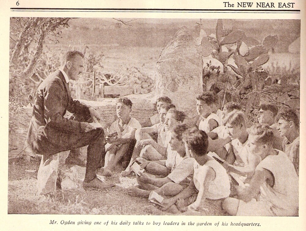 Mr. Ogden gives one of his daily talks to boy leaders in the garden of his headquarters.