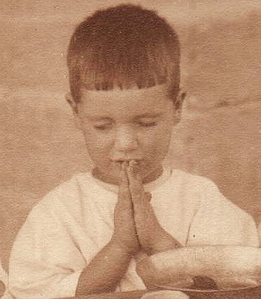 Closeup of Antranig Karjian saying grace at the Birds' Nest orphanage in Sidon (now Lebanon), c. 1925
