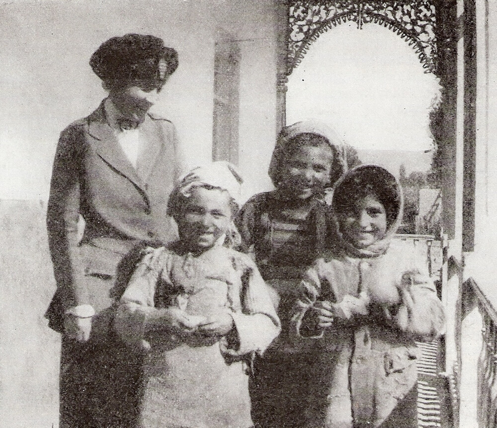 Near East Relief worker Dorothy H. Sutton with three orphan girls at the Erivan (Yerevan) orphanage, Armenia. The New Near East, November 1922.