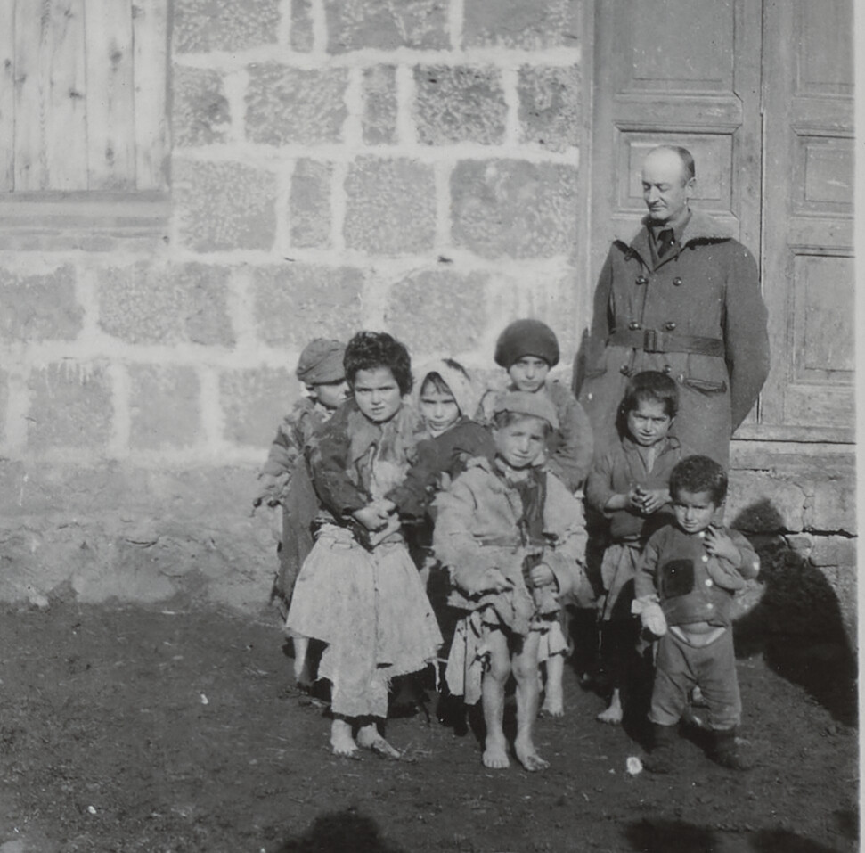 Near East Relief worker R.M. Davidson with orphan children at Erivan, Armenia, April 1922.