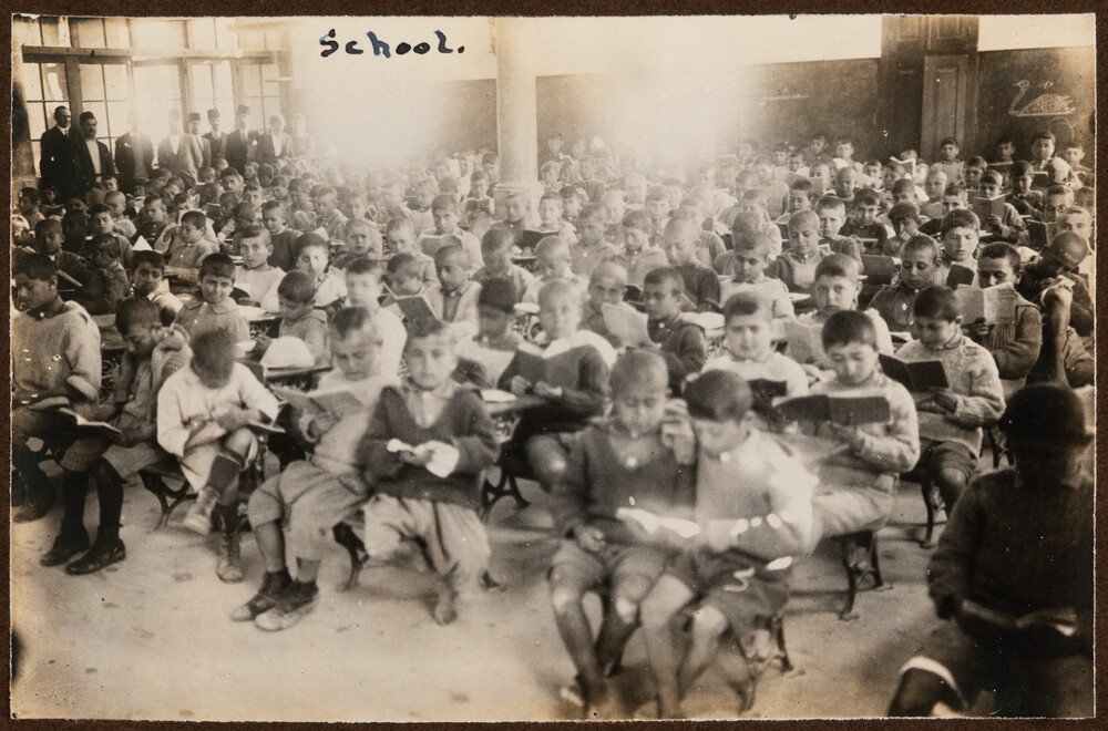 Orphan boys study in a crowded schoolroom. Miamia, 1922.