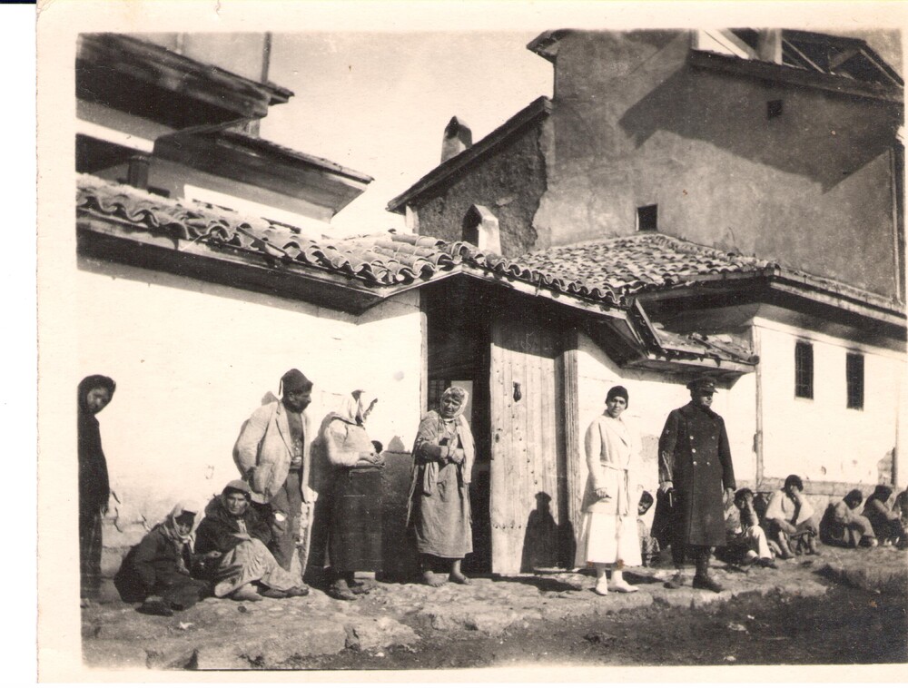 Refugees too weak to go on rest at the door. Sivas, 1922.