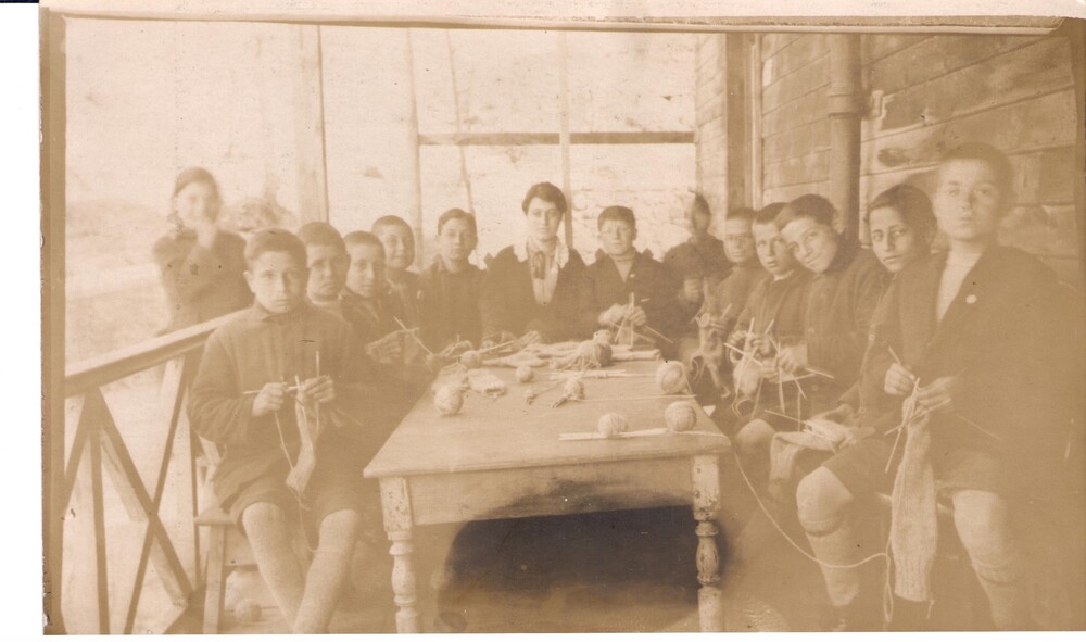 Boys knit stockings with their teacher. Bardizag, c. 1921.