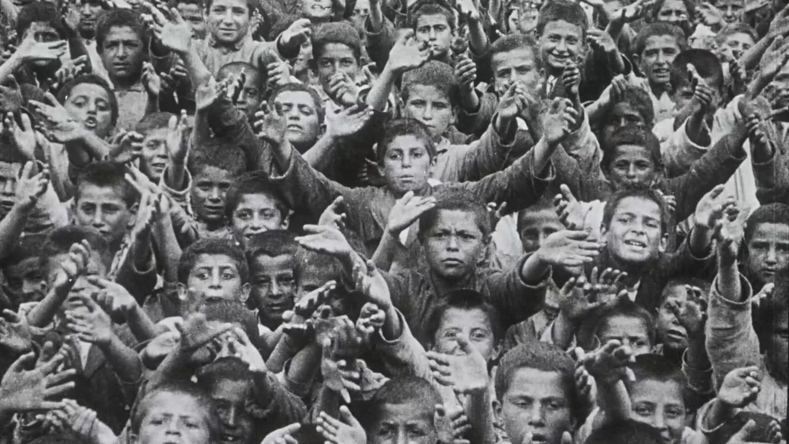 A crowd of children holding out their hands, from Armeniernot und Christenhilfe (1930)